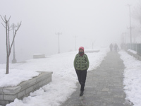 A boy walks amid dense fog in Srinagar, Indian Administered Kashmir on 15 January 2020. The temprature in Srinagar dipped to -8.4 Celsius on...
