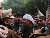 Supporters of India's main opposition Congress party scuffle with police as they try to cross barricades during a protest against new farm l...