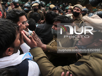 Supporters of India's main opposition Congress party scuffle with police as they try to cross barricades during a protest against new farm l...