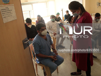 A healthcare worker observes volunteers after getting a Covid-19 coronavirus vaccine at a hospital in New Delhi on January 16, 2021. India b...