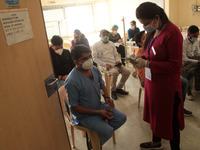 A healthcare worker observes volunteers after getting a Covid-19 coronavirus vaccine at a hospital in New Delhi on January 16, 2021. India b...