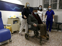 Nurses help an elderly man after his vaccination at Evangelismos hospital as Greek health authorities start inoculating the elderly. In Athe...