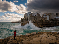 A curious lady admires the storm and the waves that hit the Lama Monachile cliff in Polignano a Mare on January 16, 2021.
The arrival of th...