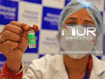 A medic shows a Covishield vaccine vial, after the virtual launch of the COVID-19 vaccination drive by Prime Minister Narendra Modi, at Mani...