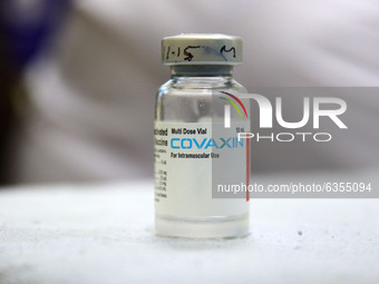 A medic shows a Covaxin vaccine vial, after the virtual launch of the COVID-19 vaccination drive by Prime Minister Narendra Modi, at Haribak...
