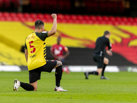  William Troost-Ekong of Watford takes the knee prior to the Sky Bet Championship match between Watford and Huddersfield Town at Vicarage Ro...