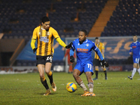 Colchesters Callum Harriott passes the ball with  Cambridges Harvey Knibbs watching on during the Sky Bet League 2 match between Colchester...