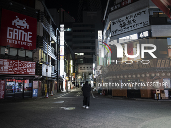 Man who tout for a bar stands deserted street after 8 p.m. in Tokyo, Japan on 11 January 2021. (