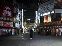 Man who tout for a bar stands deserted street after 8 p.m. in Tokyo, Japan on 11 January 2021. (