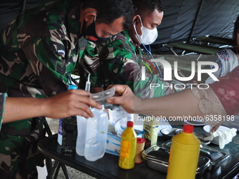 Doctors from Indonesian National Army personnel are examining the health conditions of survivors at the Manakarra Stadium refugee post, Mamu...