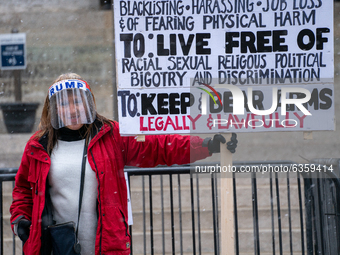 A Trump supporter demonstrates during an armed protest at the Ohio Statehouse ahead of the inauguration of President-elect Joe Biden in the...