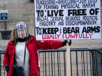 A Trump supporter demonstrates during an armed protest at the Ohio Statehouse ahead of the inauguration of President-elect Joe Biden in the...