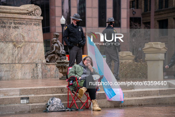 A man speaks through a megaphone during an armed protest at the Ohio Statehouse ahead of the inauguration of President-elect Joe Biden in th...