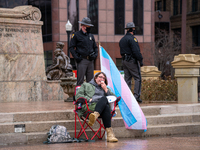 A man speaks through a megaphone during an armed protest at the Ohio Statehouse ahead of the inauguration of President-elect Joe Biden in th...