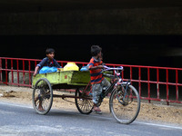 Indian minor  chilldren push trolly,loaded with drinking water,on World day against child labour,in Allahabad on June 12,2015. (