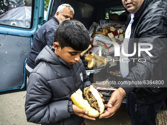 A refugee boy gets a meal at the Serbia-Croatia border, between Berkasovo and Bapska on September 26, 2015. A record number of refugees from...