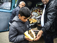 A refugee boy gets a meal at the Serbia-Croatia border, between Berkasovo and Bapska on September 26, 2015. A record number of refugees from...