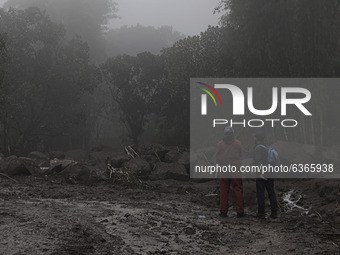 Rescuers are seen at a village in Bogor, West Java, Indonesia, on January 20, 2021 after a massive flash flood hit the Gunung Mas Puncak, We...