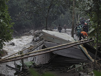 Rescuers are seen at a village in Bogor, West Java, Indonesia, on January 20, 2021 after a massive flash flood hit the Gunung Mas Puncak, We...