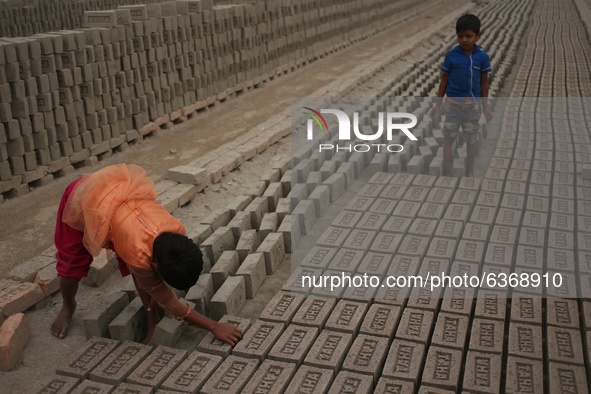 From left, Rabeya (8) and Samidul (6), work at a brick making field in Dhaka, Bangladesh on Thursday , January 21, 2021. They earn around 5-...