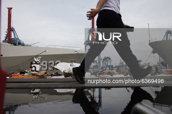 A man walks near the wreckages of crashed Sriwijaya Air flight SJ182 on the last day of SAR Operation at port of Tanjung Priok, Jakarta on J...