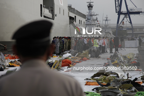 Indonesian police officer stand guard near the wreckages of crashed Sriwijaya Air flight SJ182 on the last day of SAR Operation at port of T...
