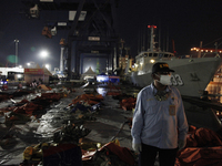 Member of Indonesian National Transportation Safety Commite stands near the wreckages of crashed Sriwijaya Air flight SJ182 on the last day...