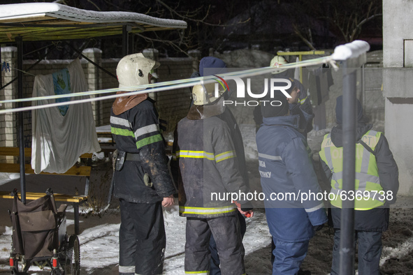 Firefighters near the house, in Kharkiv, Ukraine, on January 21, 2021.  A fire at a private nursing home in the Ukrainian city of Kharkiv ki...