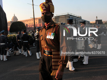 An Indian Armed Force personnel reacts to camera after the Beating Retreat ceremony rehearsals ahead of the Republic Day parade, at Raisina...