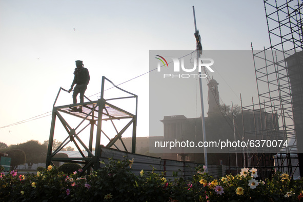 A painter gives final touch to a stand ahead of the Republic Day parade, at Raisina Hills on January 21, 2021 in New Delhi. India celebrates...