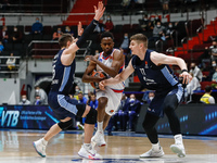 Rodrigue Beaubois (C) of Anadolu Efes in action against Mateusz Ponitka (L) and Arturas Gudaitis of Zenit St Petersburg during the EuroLeagu...