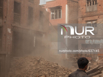 A man watches neighbors demolish destroyed houses in Bhaktapur, South of Kathmandu. Nepal, 5/31/2015. John Fredricks (
