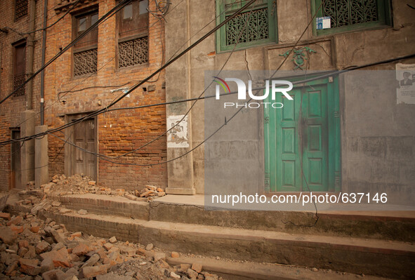 A green door becomes a noticeable feature on a destroyed and abandoned street in Bhaktapur, South of Kathmandu, Nepal. 5/31/2015. John Fredr...