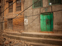 A green door becomes a noticeable feature on a destroyed and abandoned street in Bhaktapur, South of Kathmandu, Nepal. 5/31/2015. John Fredr...