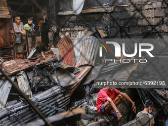 A second alarm fire hits in Muslim Community in 18th Avenue, Cubao, Quezon City on morning of January 30, 2021. Residents back to their prop...