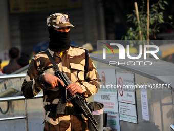 A Central Industrial Security Force (CISF) personnel stands guard at the entry point of Rajiv Chowk Metro Station in New Delhi, India on Jan...