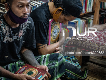 student hug his quran. Islamic boarding school for punk and street children in Ruko Cimanggis, Ciputat, South Tangerang, Banten, Indonesia,...