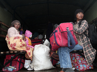 Residents were in the car with a military truck carrying their belongings to be evacuated after the latest eruption of the Sinabung volcano...