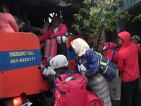 Residents climbed into a military truck carrying their belongings to be evacuated after the latest eruption of the Sinabung volcano followin...