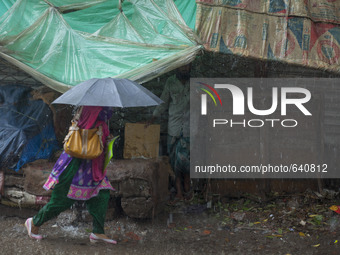 An women walking on road during heavy rain in Dhaka (