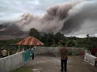 An Indonesian village covering his face observe the activities of Mount Sinabung spews ash pyroclastic launch as seen from the village of Ti...