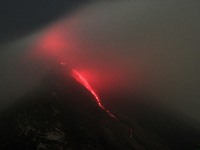 A long exposure image shows the hot lava that melts from the crater of Mount Sinabung as seen from Tiga Serangkai village, in Karo, North Su...