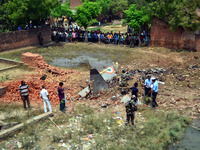 IAF officials equire near crashed Jaguar fighter plane of IAF,at Naini ,in Allahabad on June 16,2015. (