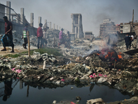 People make their move as garbage fire creates toxic smoke at a low-income area on the outskirt of Dhaka, Bangladesh on Monday, February 08,...