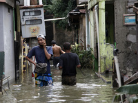 Residents wade floods in South Jakarta, on February 9, 2021. Floods was submerged some riverbanks areas in Jakarta after heavy rains occured...
