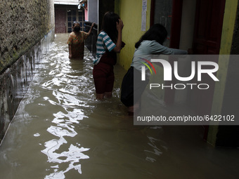 Residents wade floods in South Jakarta, on February 9, 2021. Floods was submerged some riverbanks areas in Jakarta after heavy rains occured...