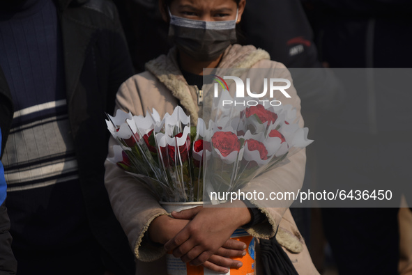 A Girl selling Red rose flower on the occasion of Valentine’s Day in Patan Durbar Square, Lalitpur, Nepal on Sunday, February 14, 2021. 