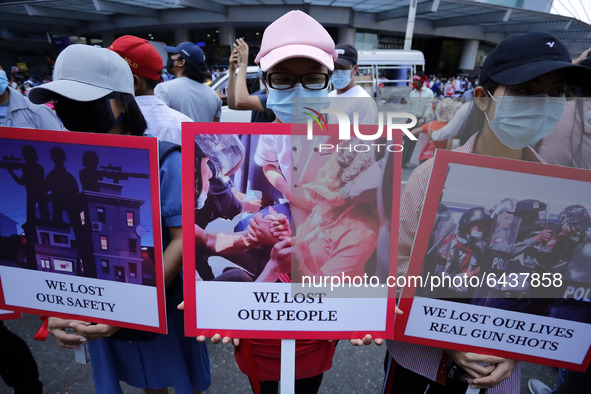 Myanmar protesters hold placards during a demonstration against the military coup in Yangon, Myanmar on February 14, 2021. 