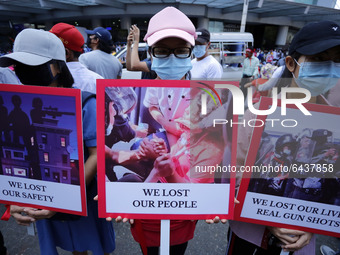 Myanmar protesters hold placards during a demonstration against the military coup in Yangon, Myanmar on February 14, 2021. (