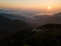 A drone view over the sunrise from Kowloon Peak in Hong Kong, China, 15 Feb 2021, and the people observing the sunrise from the Kowloon Peak...